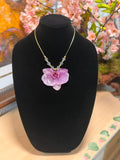 Natural orchid encapsulated in resin, paired with a 14K gold-plated necklace featuring crystal beads.